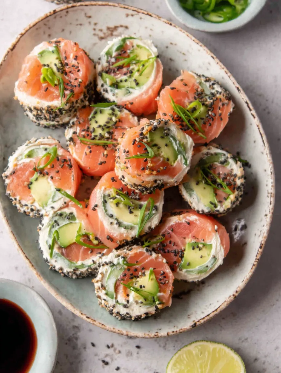 A plate of smoked salmon and cream cheese roll-ups.