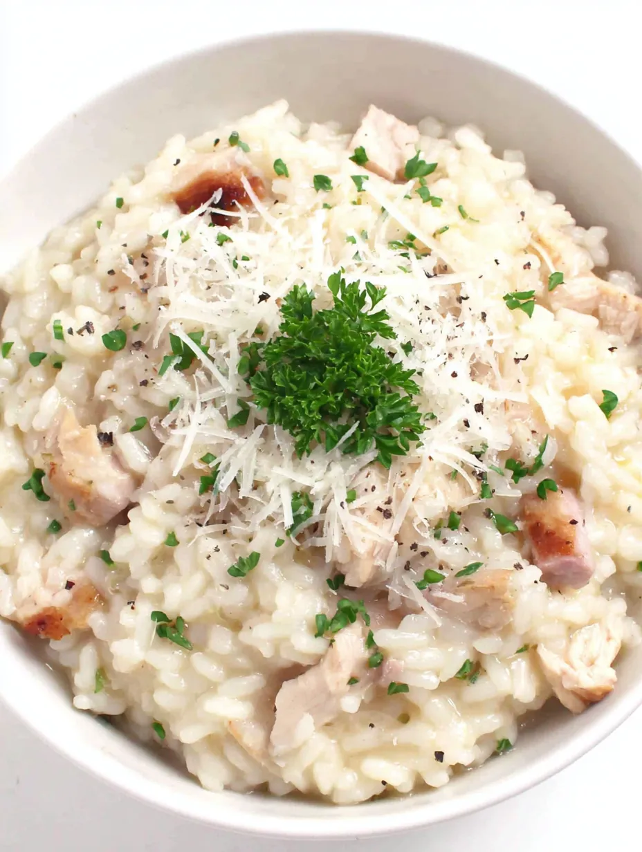 A bowl of rice with chicken and cheese.