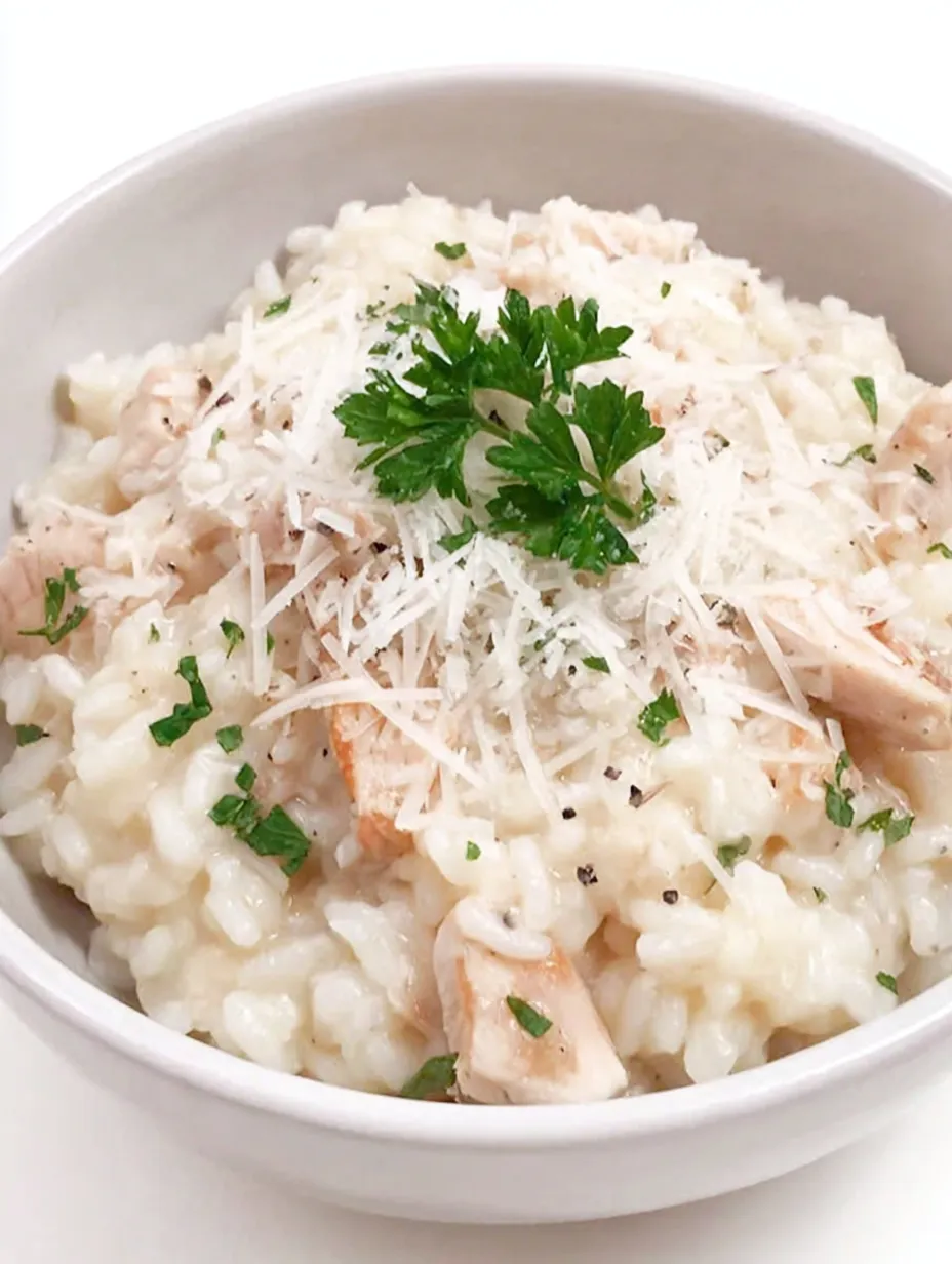 A bowl of rice with chicken and cheese.